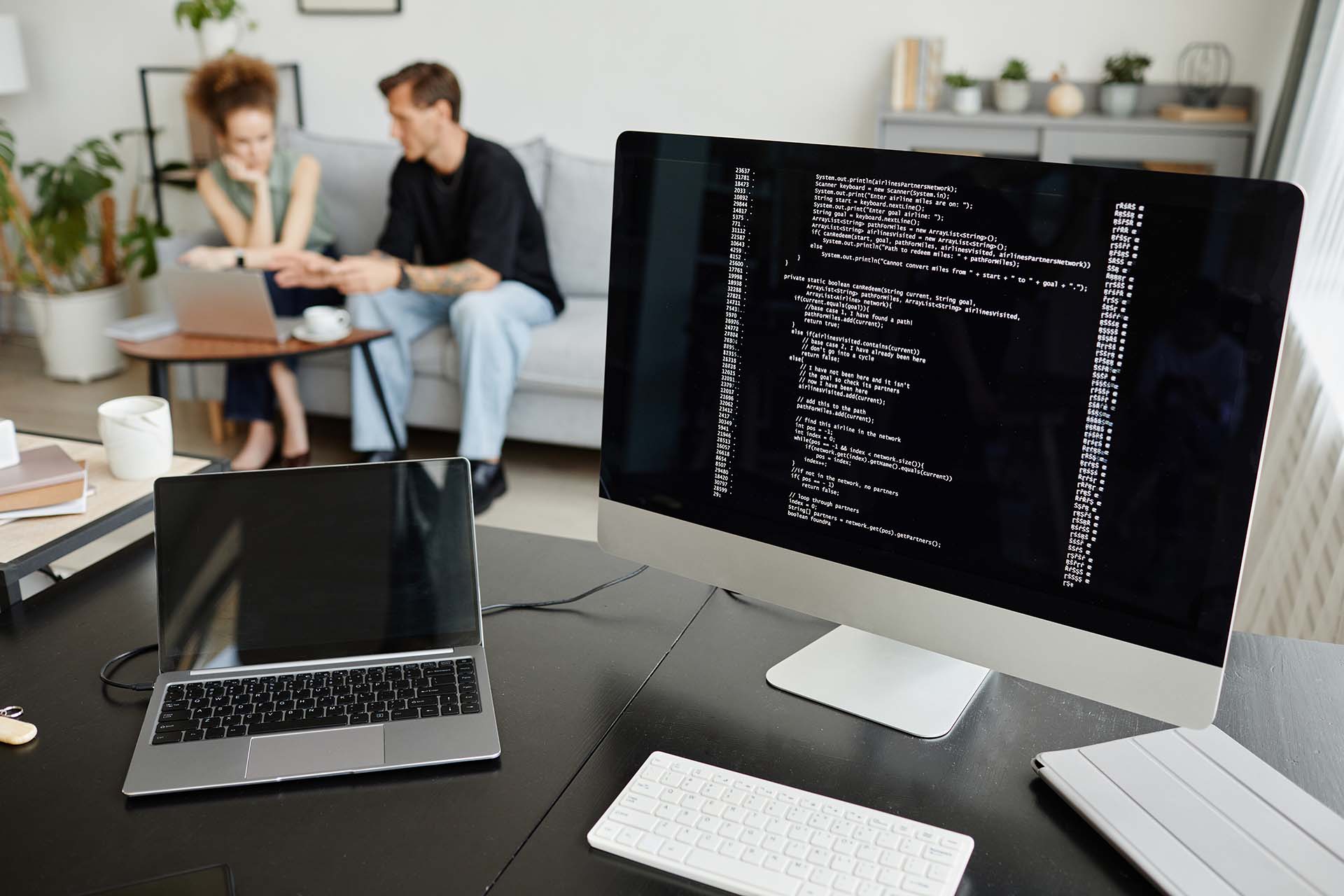 Computer workstation in office with code on screen