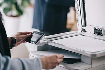 Person interacting with an office printer