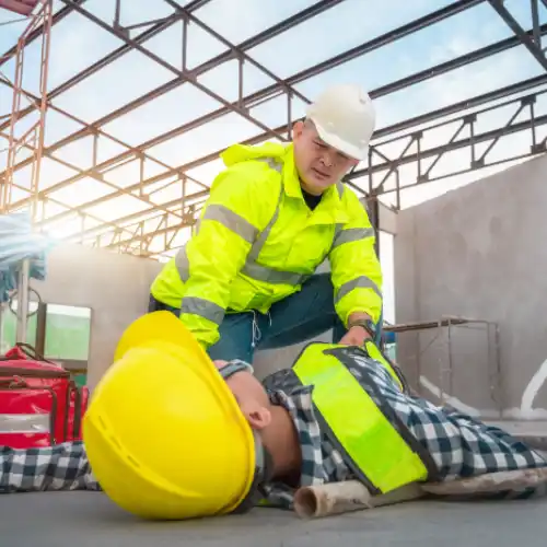 Worker has fallen on the job and safety manager is assiting Worker has fallen on the job and safety manager is assiting