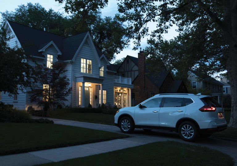 driveway with lit up home