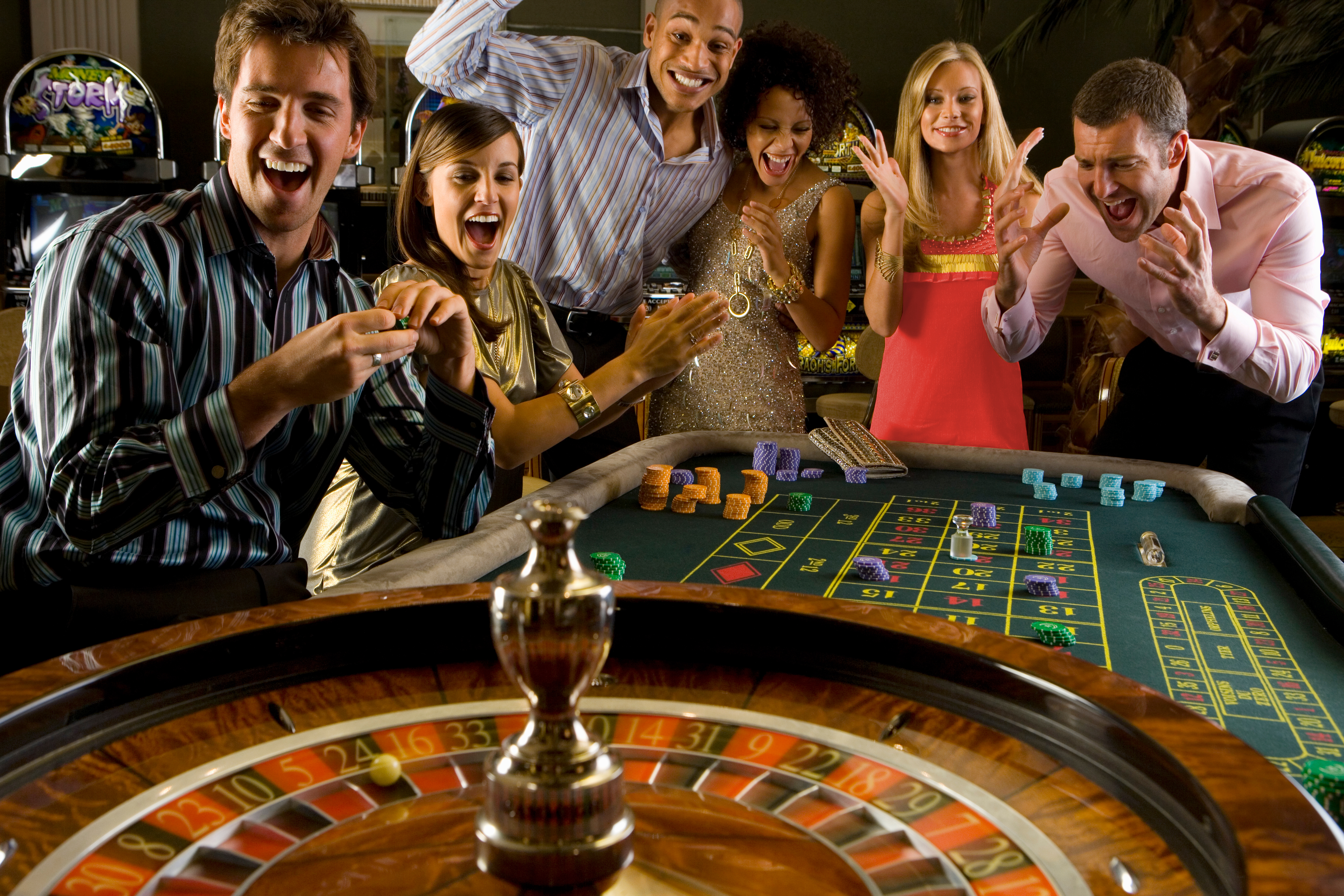 Six adults having fun gambling at a casino