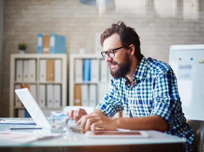 Person in office working on laptop