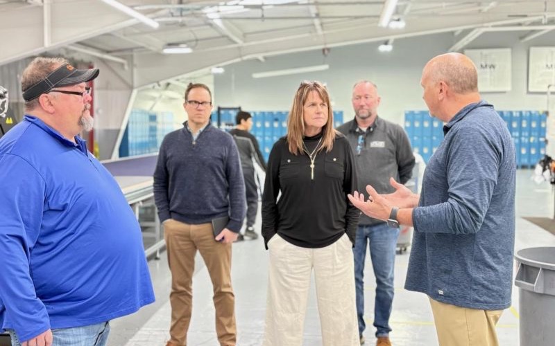 Dalene in conversation with colleagues on a shop floor