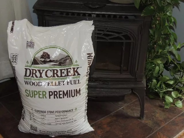 a bag of Drycreek wood pellets by a stove