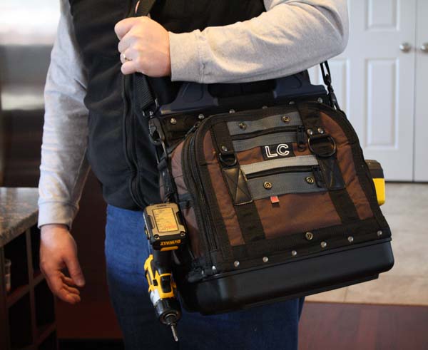 a technician carries a Veto Pro Pac tool bag
