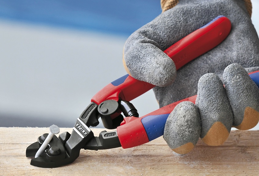 a knipex plyers pulling a nail from a board