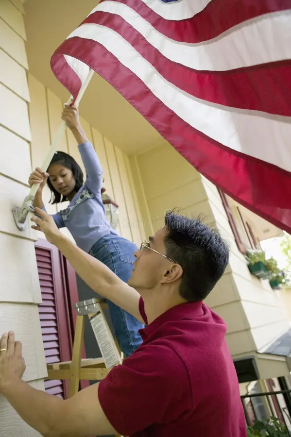 people putting a flag on their house