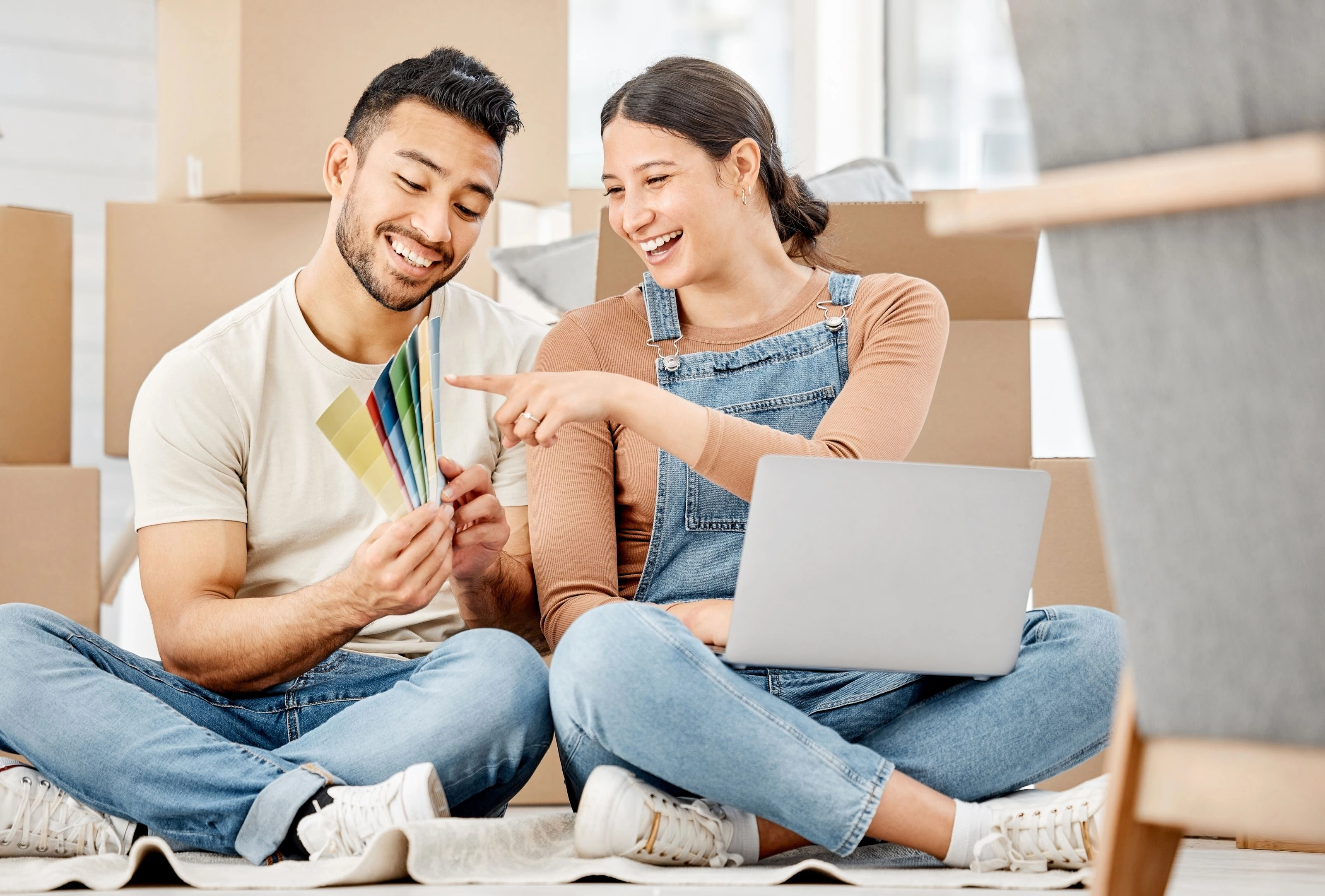 Home Remodel Checklist for an Upgrade couple laughing while choosing color from palette for home remodeling