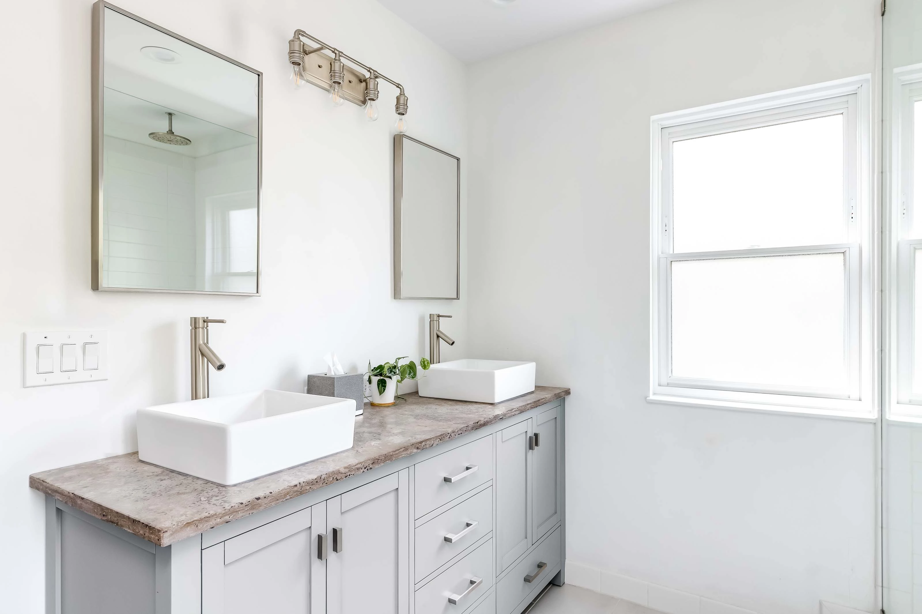 Sleek Bathroom Design A bright and modern bathroom with double sinks and large mirrors