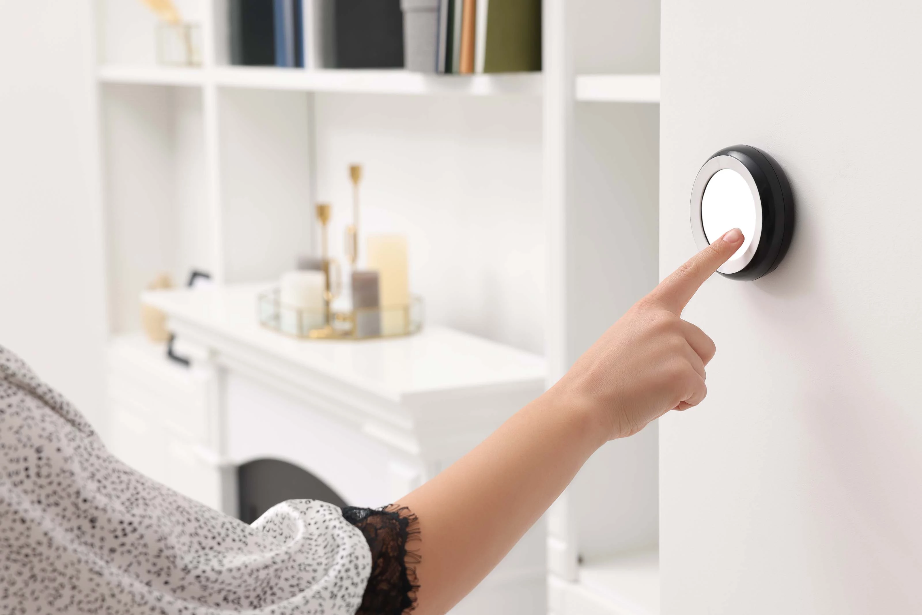 Smart Thermostat Adjustment Person adjusting the smart thermostat in a cozy living room