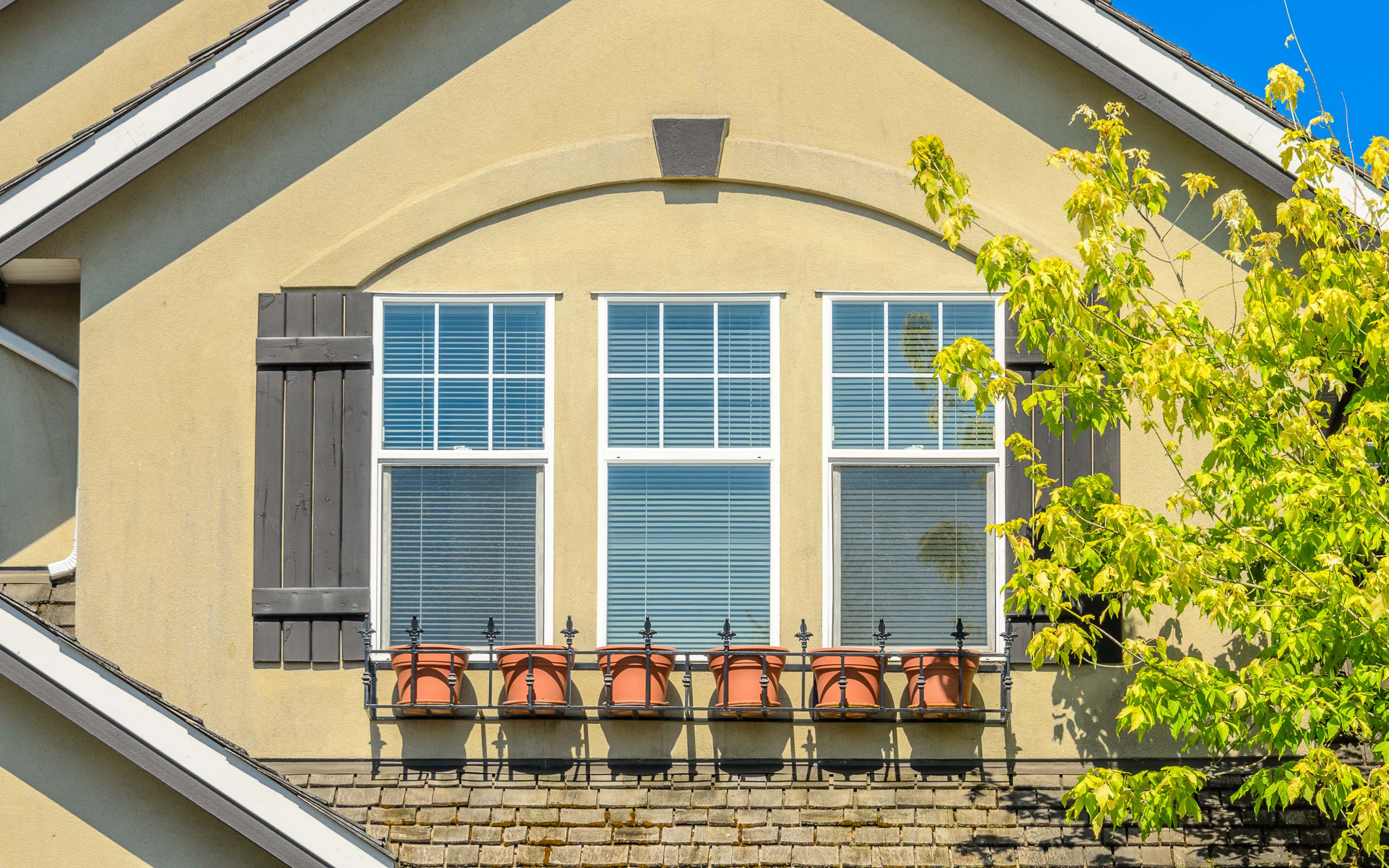 Modern home exterior with aluminum windows featuring slim frames and large glass panels for natural light