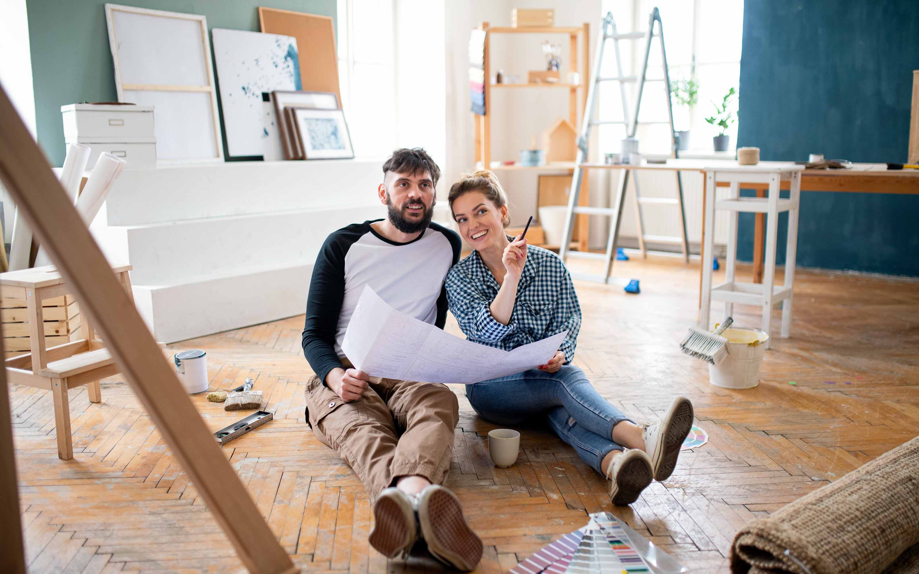 Homeowners planning a home remodeling project and reviewing renovation ideas, budgets, and design plans