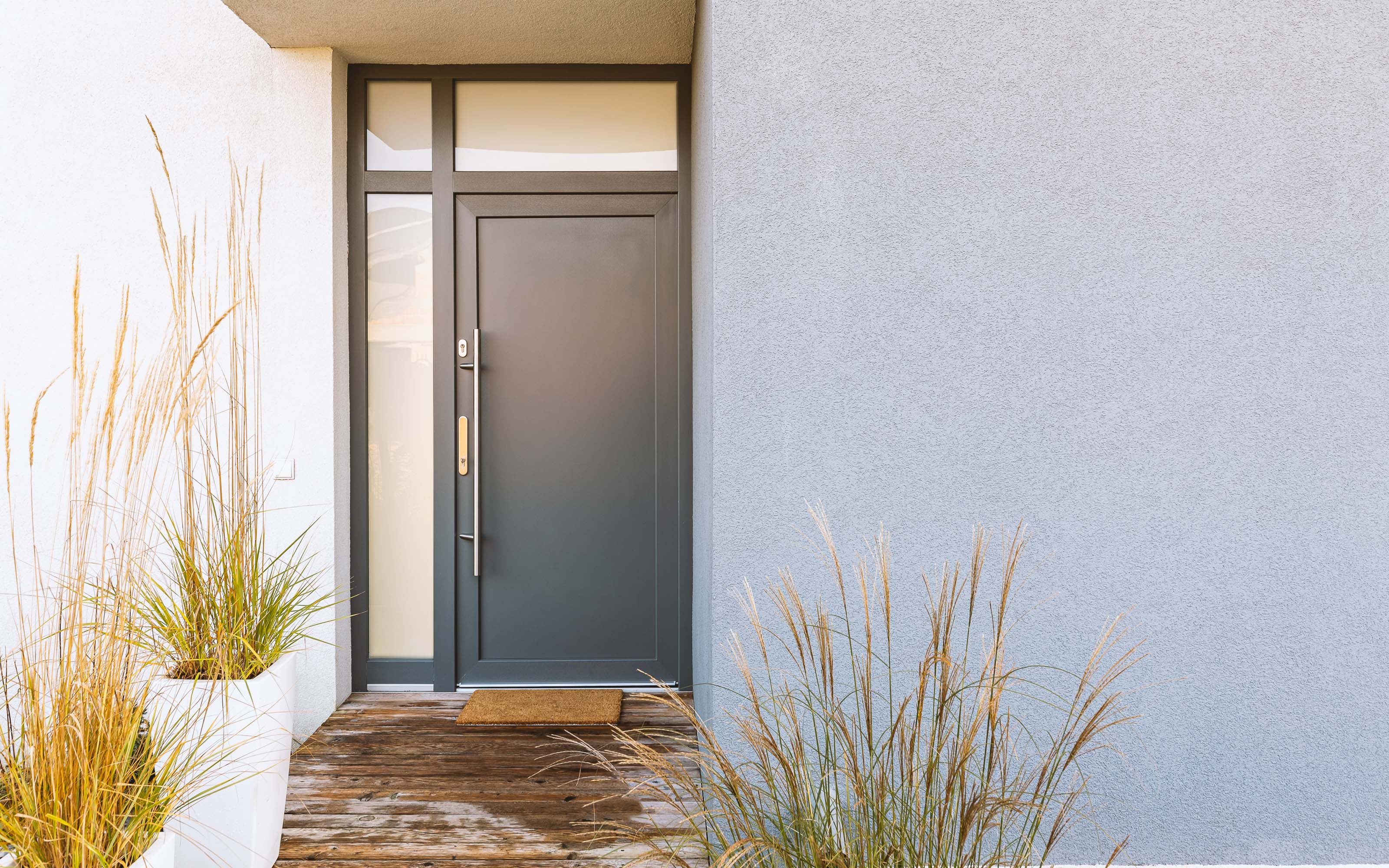 Modern home entry with sleek front door and white trim showcasing Window Depot window and door design