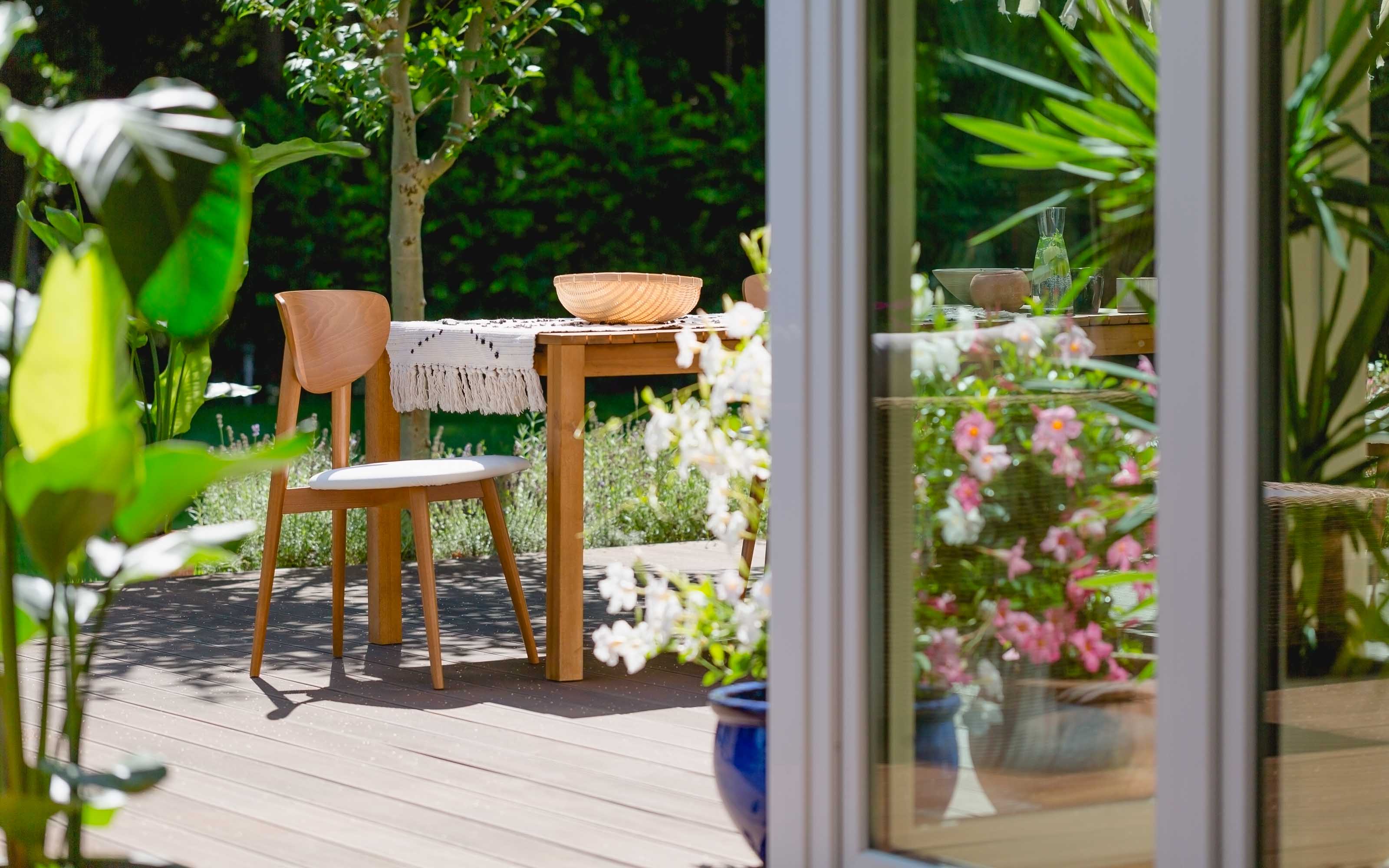 sliding glass patio doors with natural light opening to backyard garden