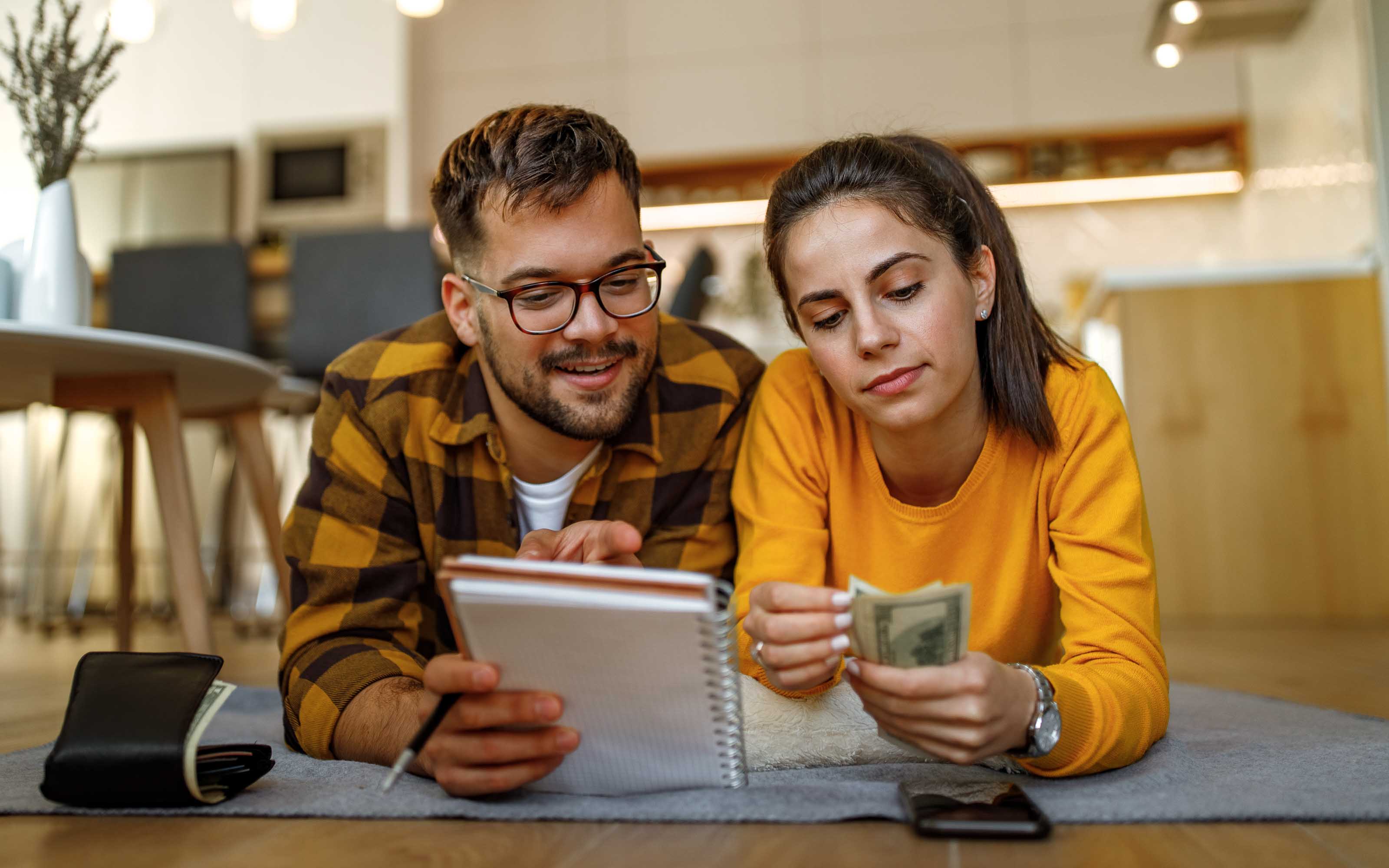 couple reviewing budget for new windows at home renovation planning
