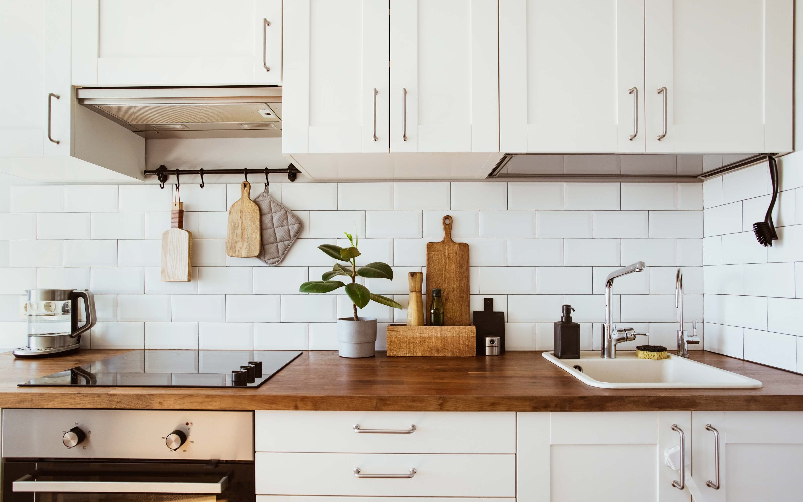 Modern small kitchen with efficient cabinet layout, light colors, and organized storage design