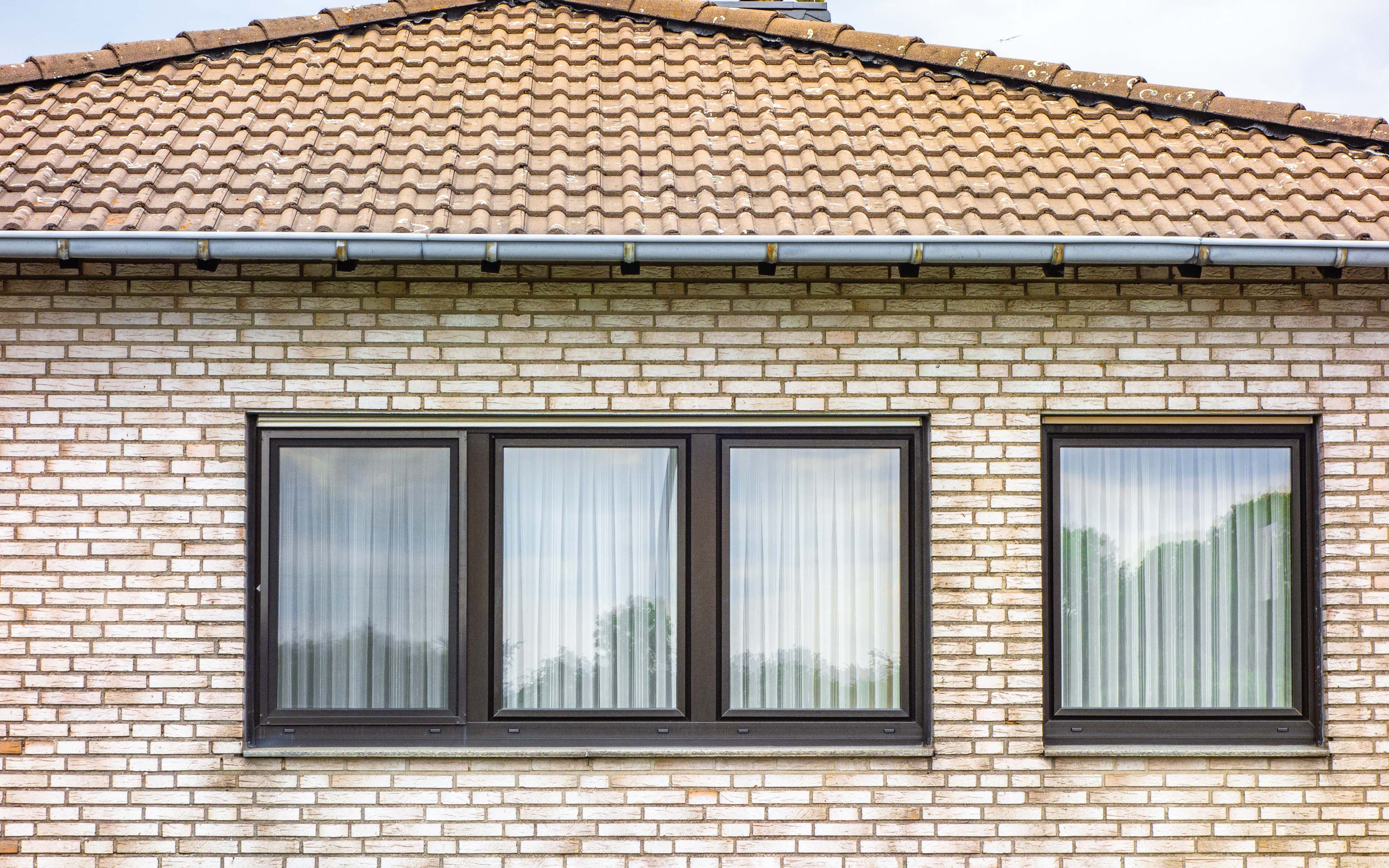 Residential home exterior with high-quality aluminum windows featuring durable frames and energy-efficient design